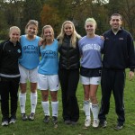 Leslie Osborne (center) with captains and coaches