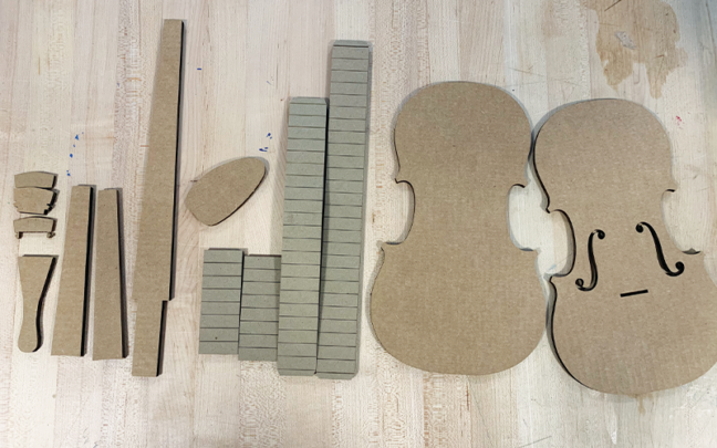 The laser cut pieces of a bass.