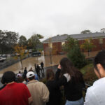 The Cup leads a parade of students to the Athletic Center.