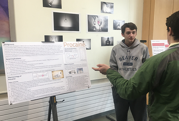 A student answering questions about his poster