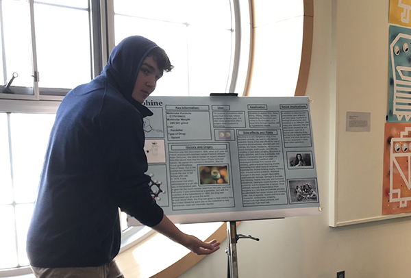 Student showing his poster