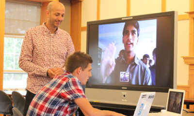 Kader Adjout and a Beaver student speak with a student from Afghanistan.